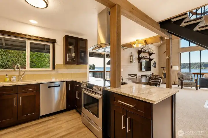 Plenty of counter space, pantry storage & a view while you cook!  Stone counters and soft close cabinets complete the beauty of this kitchen.
