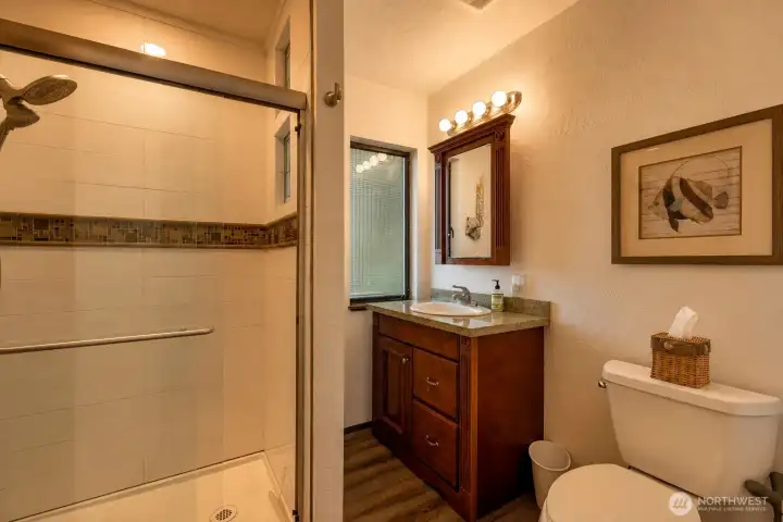 Your bathroom has heated flooring & a roomy shower and extra storage