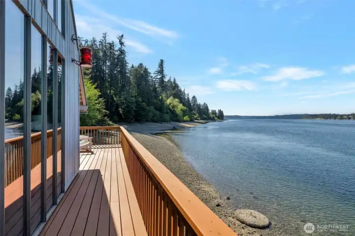 Your deck wraps all the way around 3 sides of your home.  2 sitting and eating areas, one on both sides and this walk way between.
