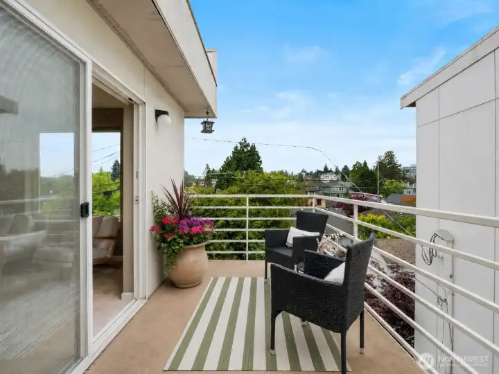 Private balcony overlooking the surrounding neighborhood, providing a comfortable outdoor retreat just off the living room. Private balcony overlooking the surrounding neighborhood, providing a comfortable outdoor retreat just off the living room.