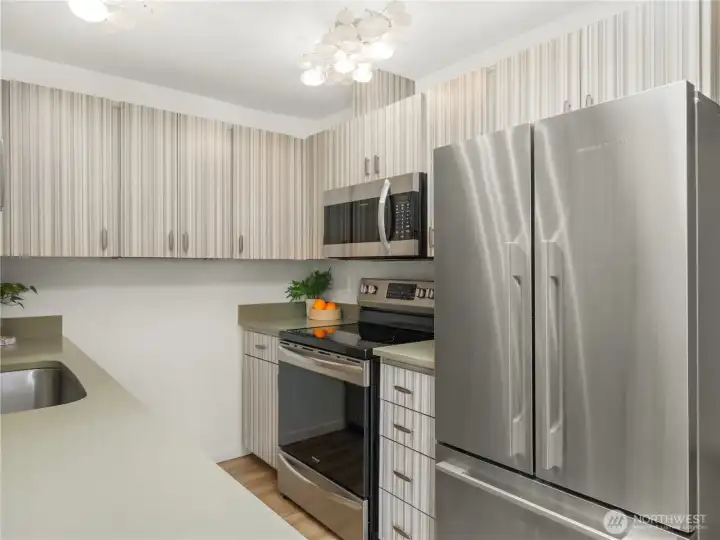 The kitchen features stainless steel appliances, extensive storage, and durable surfaces designed for everyday use and meal preparation. The kitchen features stainless steel appliances, extensive storage, and durable surfaces designed for everyday use and meal preparation.