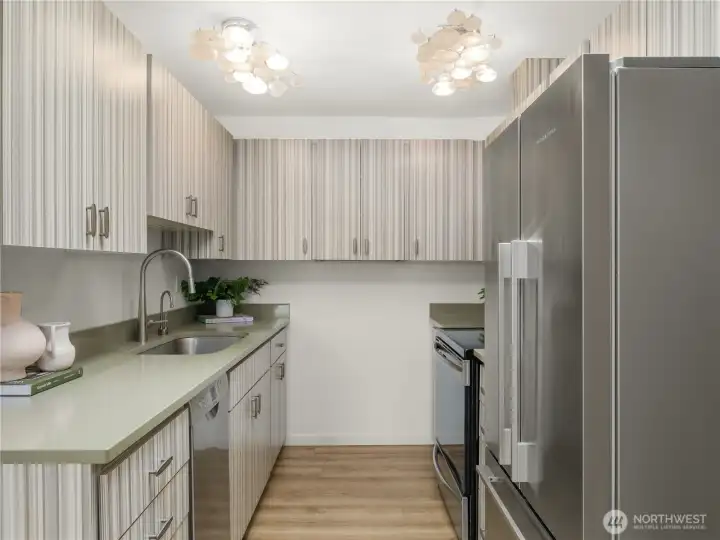 Bright and functional kitchen with extensive cabinetry, stainless steel appliances, and plenty of workspace. Bright and functional kitchen with extensive cabinetry, stainless steel appliances, and plenty of workspace.