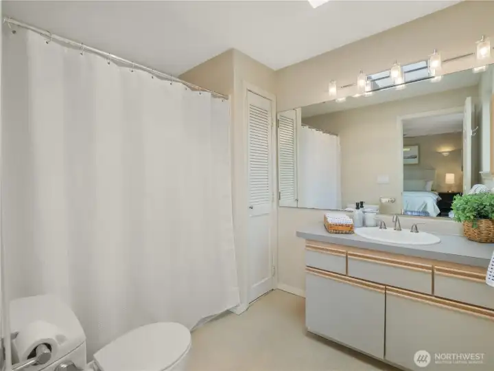 Well-appointed primary bath featuring a sizable vanity, storage closet, and full bath configuration. Well-appointed primary bath featuring a sizable vanity, storage closet, and full bath configuration.
