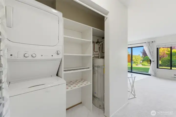 Hall closet with washer/dryer and storage area.