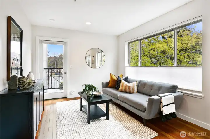 Living area has large windows looking out to views of birch trees (plus up/down shades for privacy).
