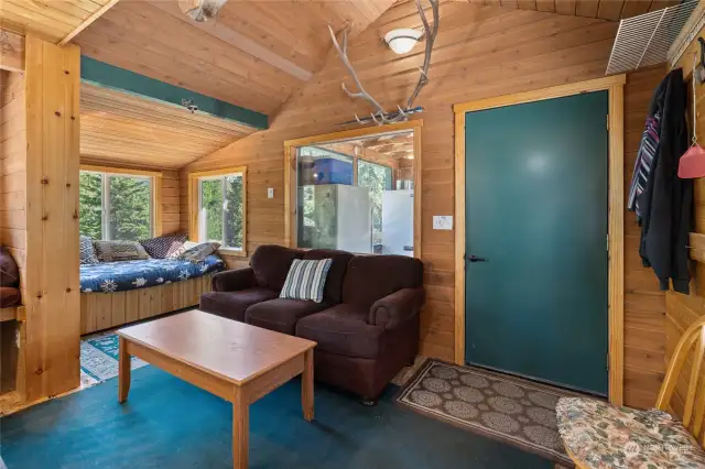 More of the living space which feautures a vaulted ceiling with t&g wood. Very pretty.