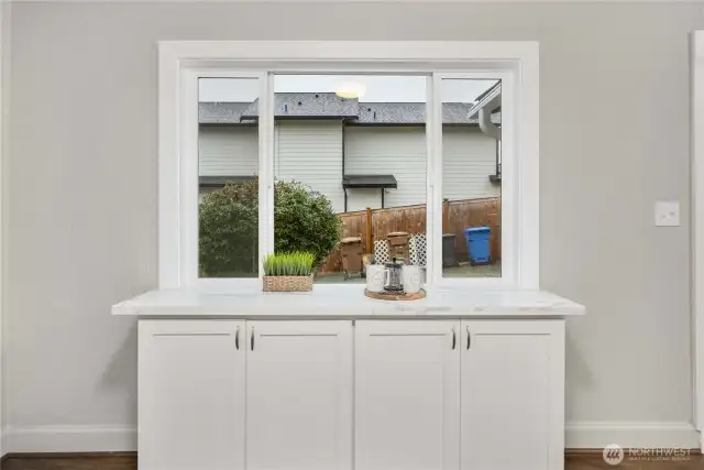 Additional storage and counterspace - perfect as a coffee bar - complete with an outlet inside the cabinet.