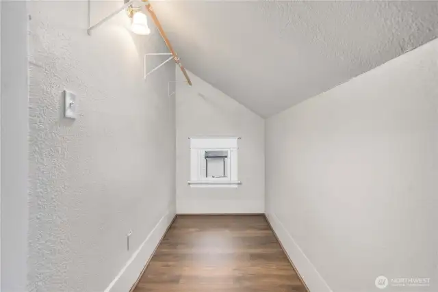 Long walk-in-closet is typical of this home's era.