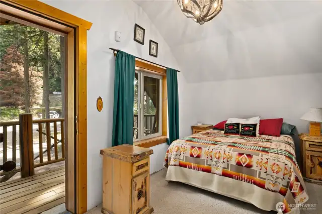 Upstairs bedroom #1. It has lovely deck to enjoy beautiful nature right from your bedroom.