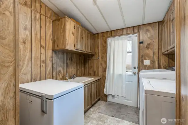 Laundry room with utility sink and access to back deck