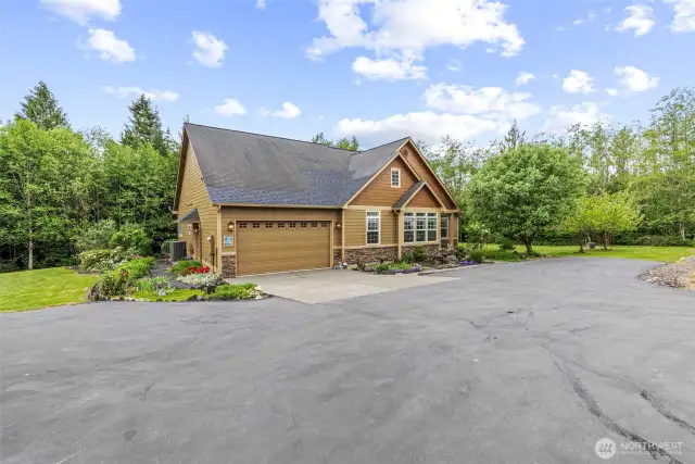 Large area finished in asphalt for extra parking, aggregate concrete garage apron.