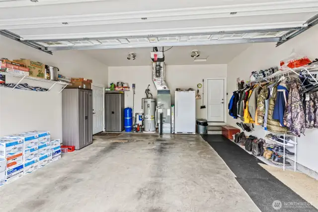 Attached garage houses ceramic well filtration/pressure tank, water heater (est 2019/2020), HVAC (new in 2021) - attached shelving and still room for additional fridge/freezer if necessary.