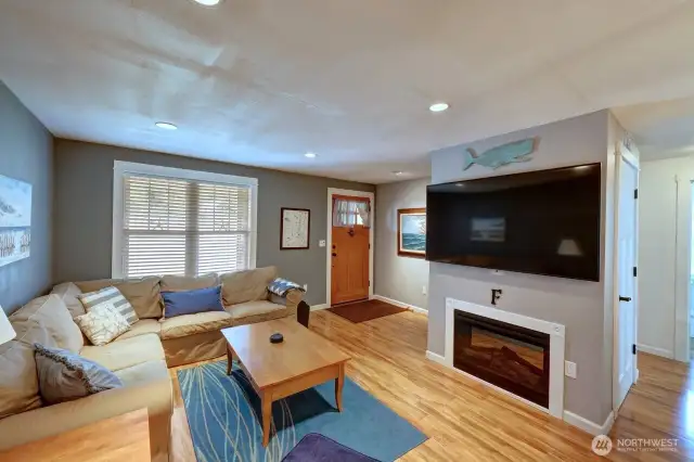 Living room with the electric fireplace for back up heat and ambiance. The hallways go to the 3 bedrooms and full bath.