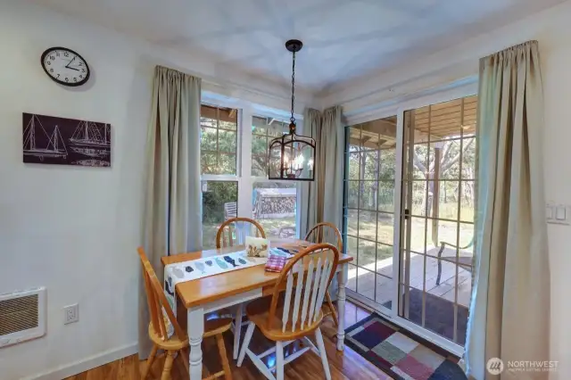 Dining area with access to the covered back deck, yard and canal.