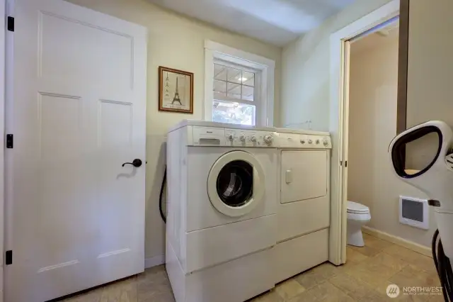 Laundry room with access to the garage and 1/2 bath.