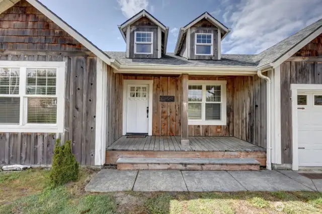 Welcome home. This covered front porch is perfect for sitting and watching the world go by.