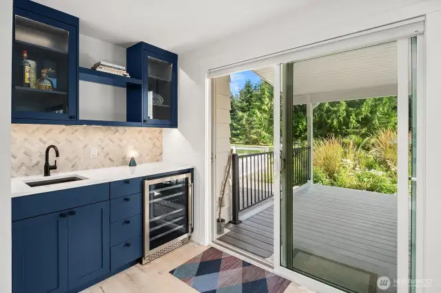 Full wet bar & drink fridge, with sliding doors leading to back deck & pool!