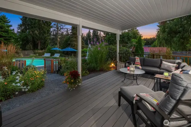 Covered outdoor deck overlooking pool area