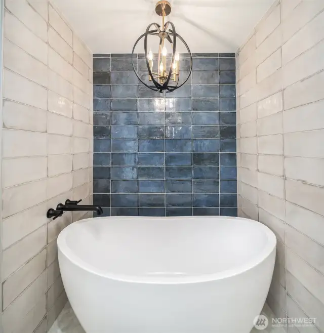 Elegant floating tub & well-appointed chandelier