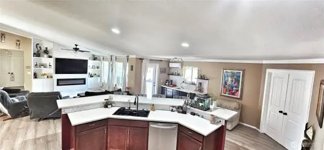View of the living room, wet bar and kitchen island.