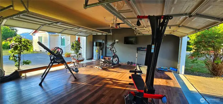 Triple car pass through garage connects to both driveways. Currently a gym!