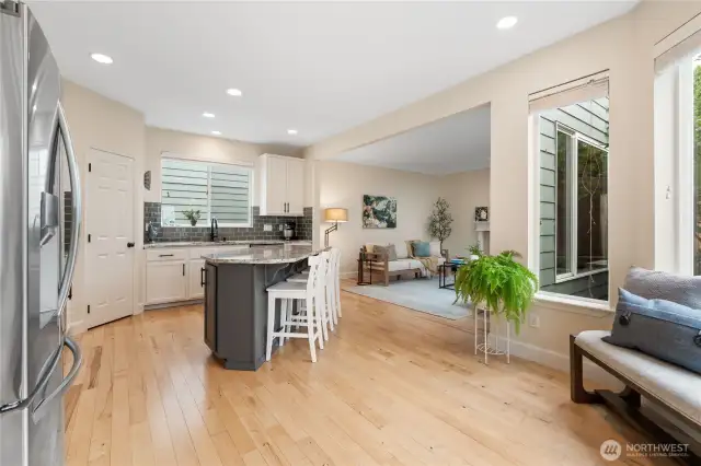 View from the dining room showcasing the open-concept kitchen with the living room just beyond.