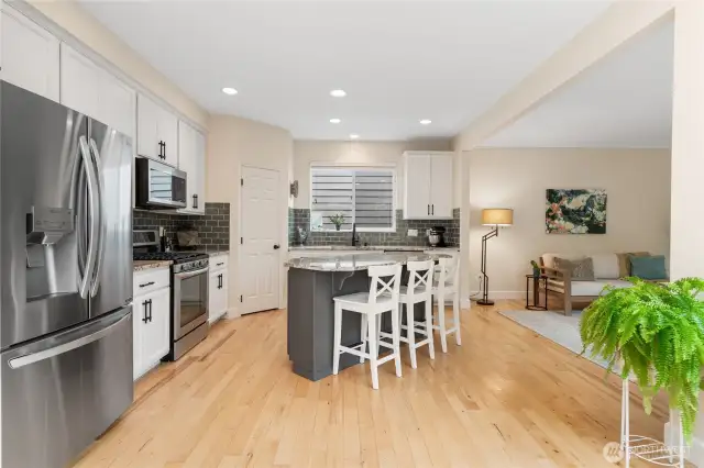 Stainless steel appliances, a large island, and ample storage make this chef’s kitchen ideal for entertaining and preparing delicious home-cooked meals.
