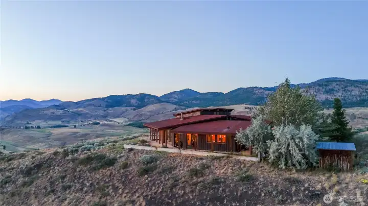 Welcome to Hilltop, a 3600 square-foot masterpiece perched above the valley on 40 private acres with unique access through Pearrygin Lake State Park.