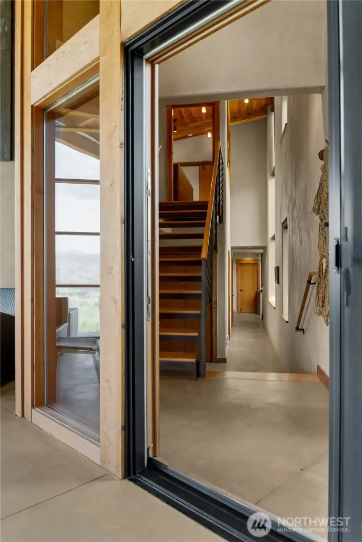 A wall of windows between the interior and the screened porch allow light to flow through the entire space morning and night.