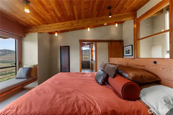 Looking through the primary bedroom to the bathroom and walk-in closet.
