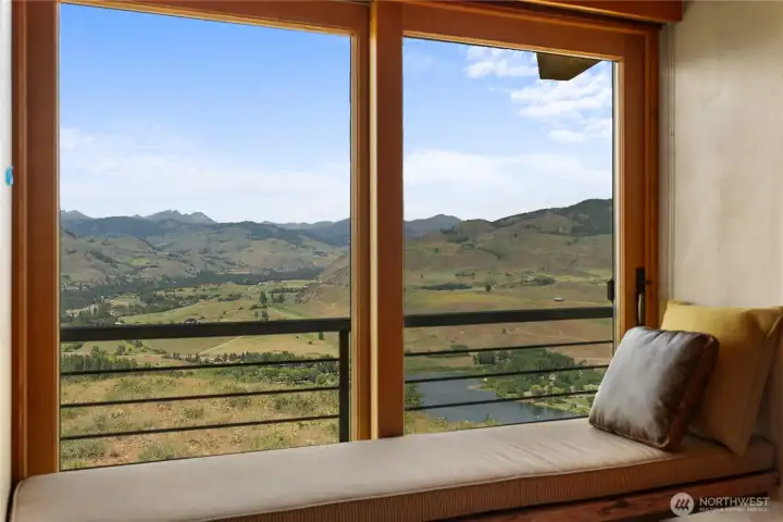 A window seat with views of Pearrygin Lake and Isabella Ridge, complete with a sliding door to let in cooling breezes and birdsong.