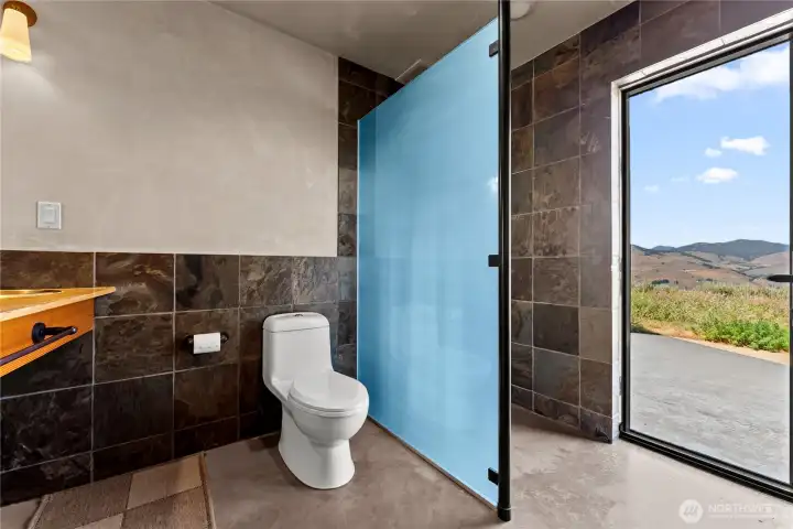 Beautiful and functional 3/4 bath with exterior access - there is an outdoor shower just around the corner on the cement patio, and the hot tub is just a few steps beyond.