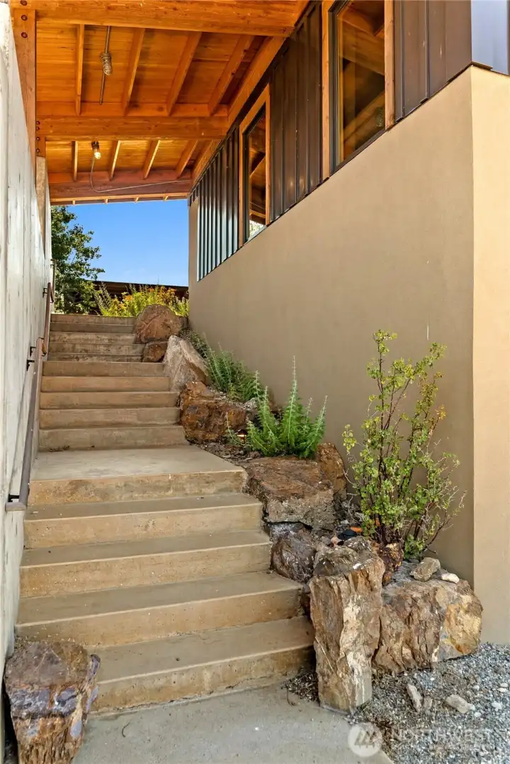 Exterior stairs leading from the garage/parking area up to the courtyard. There are interior stairs as well.