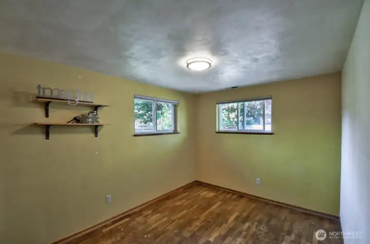 On the other side of the home, original hardwood floors in the two additional bedrooms. This one, at the back of the house, features cedar lined closet.