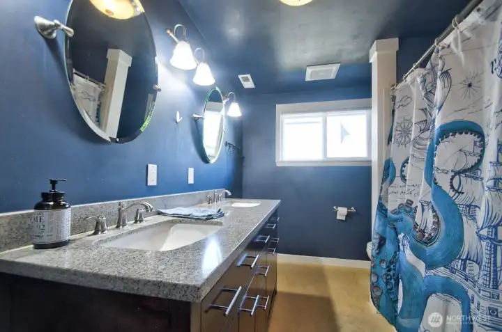 Updated main bath in between two additional bedrooms with newer flooring, newer cabinet with dual sinks and granite.