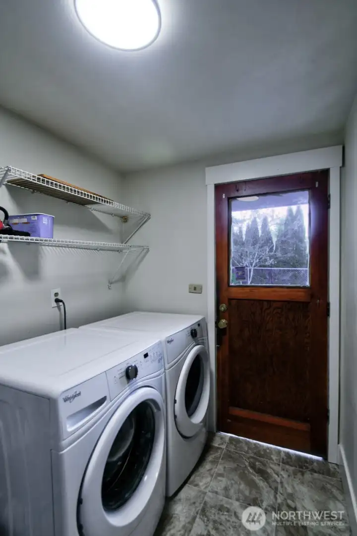 Utility room functions as a mud room with access to both the single-car attached garage and the backyard.