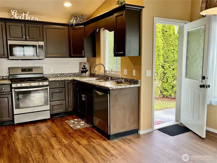 Very functional kitchen leading to dining room and cement deck outside