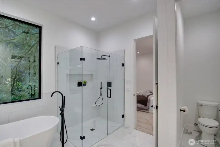Luxury Primary Bathroom with glass enclosed shower and separate soaking tub.