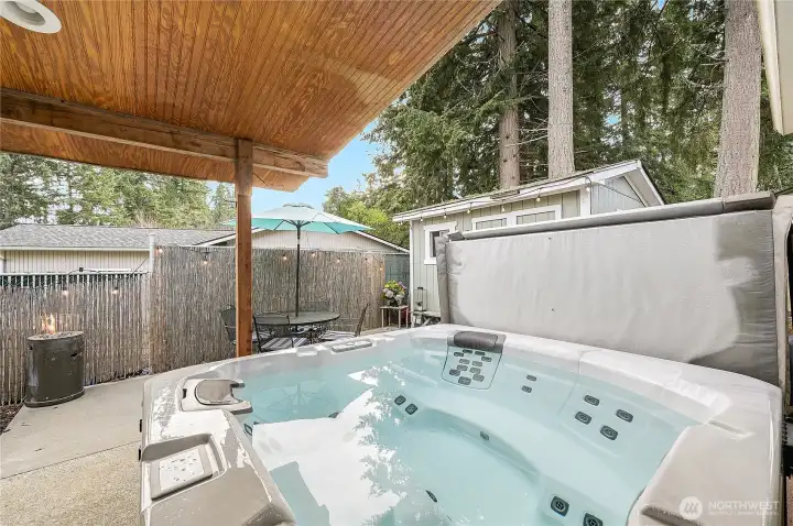 A great view of the hot tub courtyard with additional storage shed. What a cool secluded retreat!