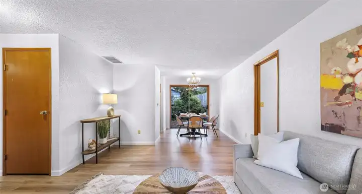 Open access from living room to dining room and large sliding glass doors provide connection with the private back patio.