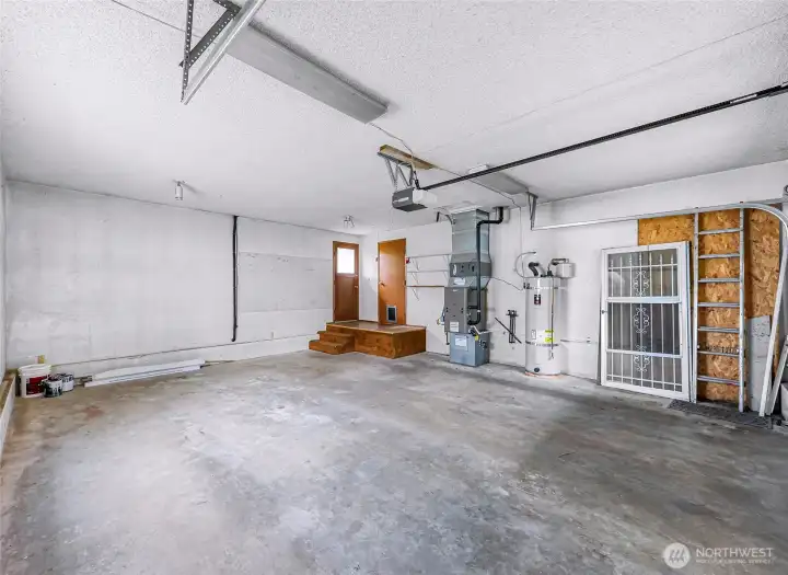 Large 2 car garage with furnace and water heater.