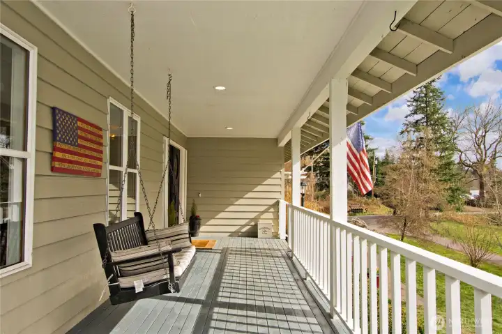 Covered wraparound porch with porch swing.