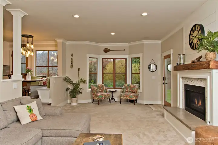 Living room featuring gas fireplace and large windows.