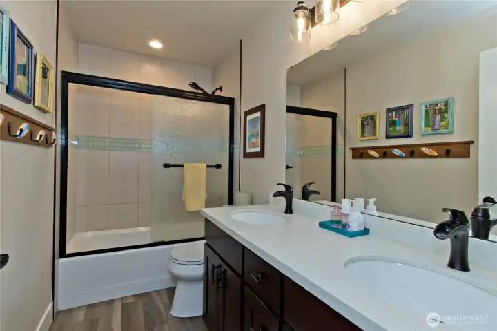 Upstairs full bathroom with updated tile & new vanity.