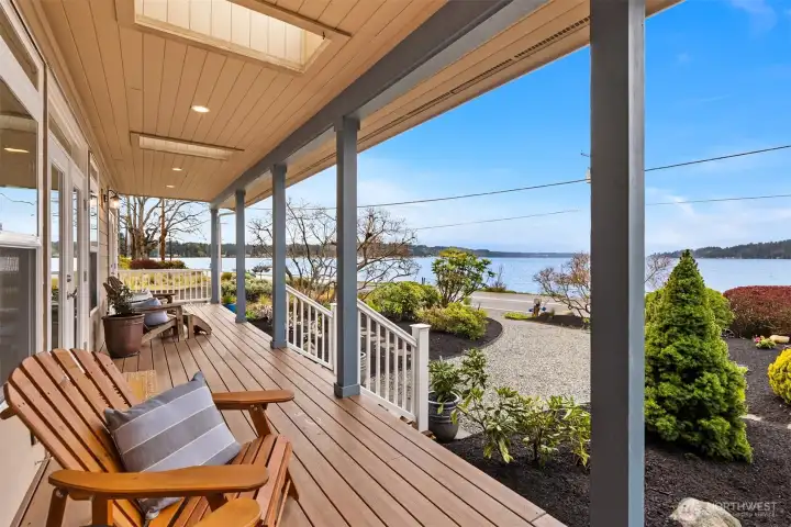 The beachside porch overlooks the beautiful manicured gardens and calming views of Rich Passage.