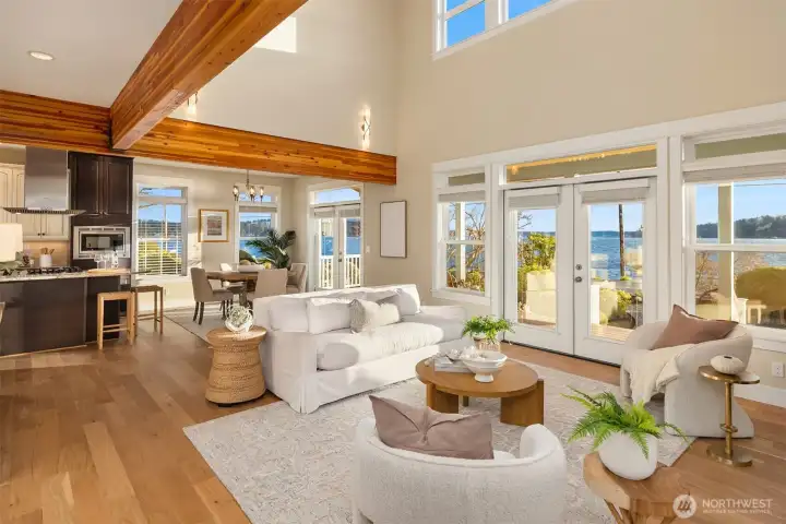 The double story great room with large windows lets in abundant natural light.  There are three sets of French doors on the main floor for great indoor/outdoor flow.