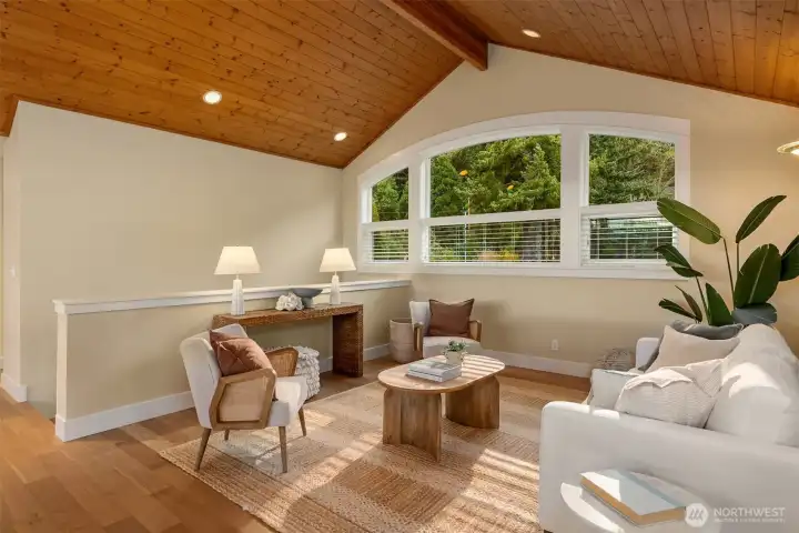 Nestled between the two upper level bedrooms is the sunny loft with vaulted ceilings.