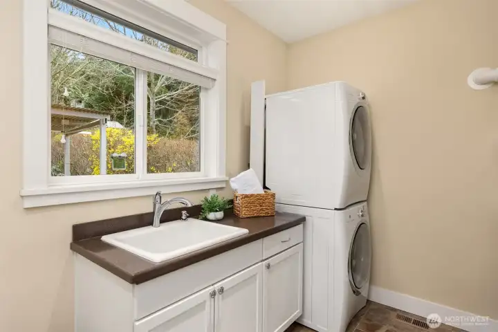 The laundry room/mudroom on the main level features a really cool utility sink with a built-in wash board!  The new tankless water heater is in a corner to the right.