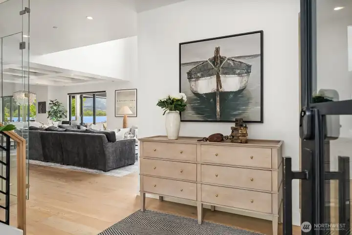 The light welcoming entry way sits adjacent to a stylish wine cellar.