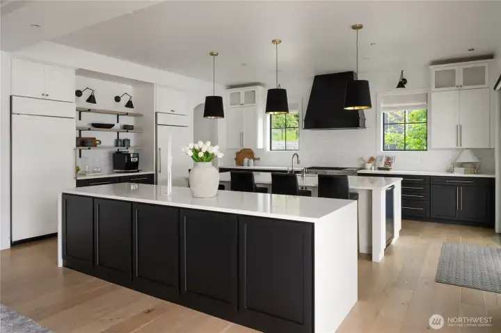 Dual islands in the gourmet kitchen and super stylish black and white motif throughout.